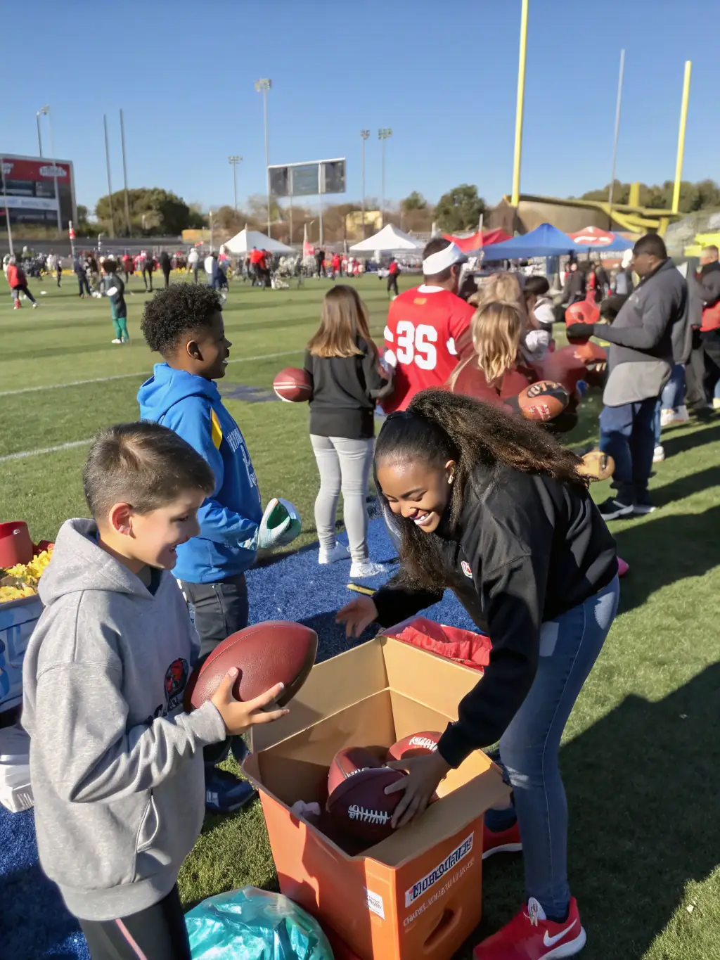 A photo of volunteers assisting with a football event, showcasing the organization's commitment to community involvement.